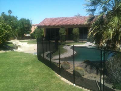 Black mesh economy pool fence in the grass Orange county